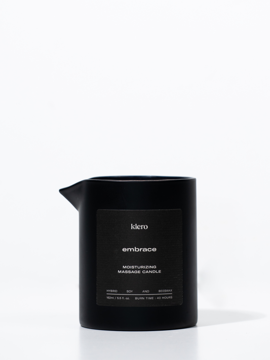 Black Klero Embrace moisturizing massage candle made from a hybrid of soy and beeswax, 162ml with a burn time of 40 hours.
